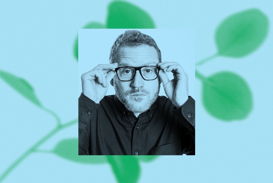 John Safran, hands on the sides of this glasses, in an inset pic with an image of a green leaf in the background. 