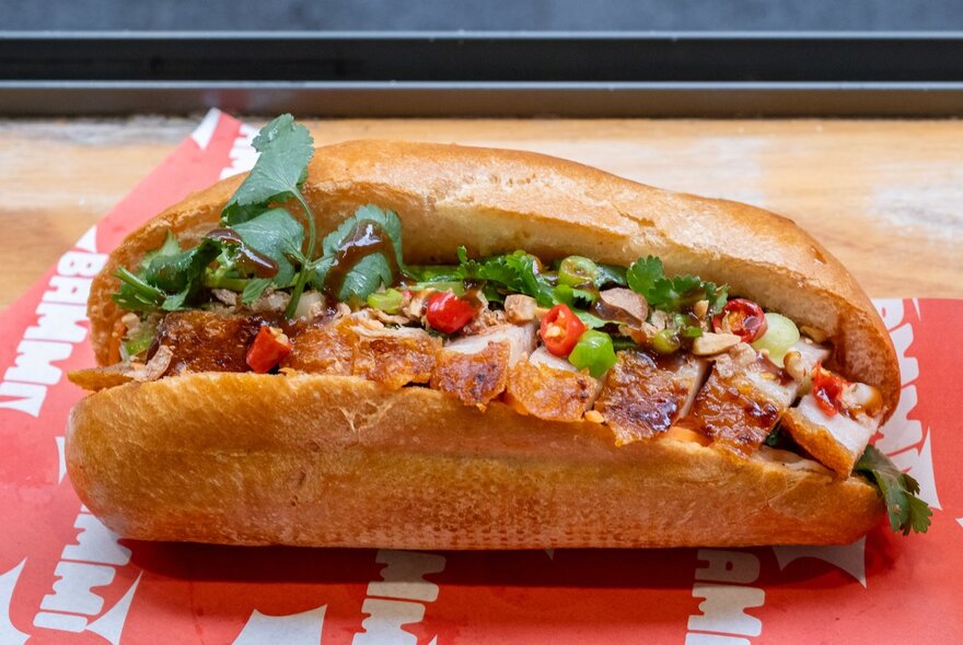 A banh mi baguette with all the trimmings including pork, coriander, chilli and spring onions.