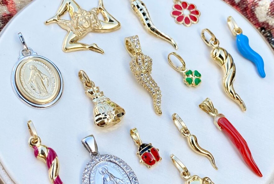 Italian gold jewellery charms including horns and Madonnas.