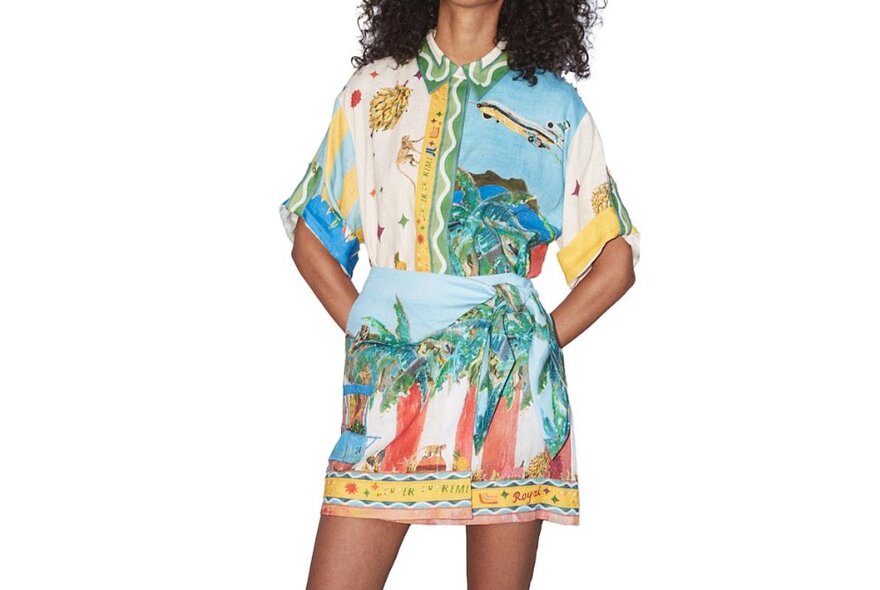 A model wearing a matching shirt and skirt in a tropical print.