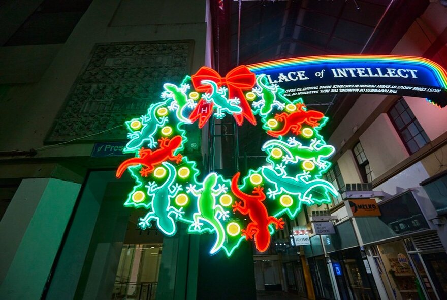 Neon light decoration of eleven lizards in the shape of a wreath. 