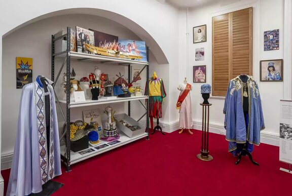 A room at Melbourne Town Hall displaying heritage items and other artefacts, clothing and objects.