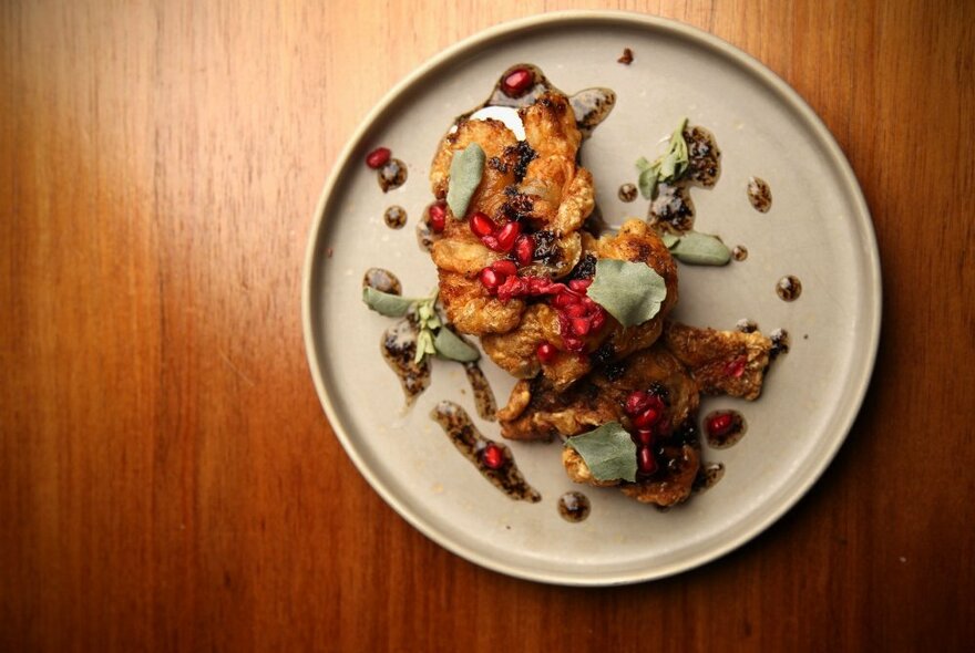 A plate of food on a wooden table.