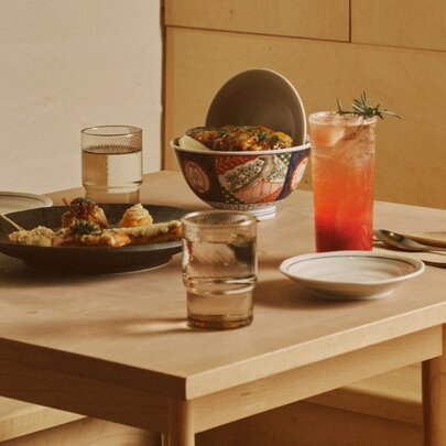Japanese dishes of food and drinks on a low wooden table.
