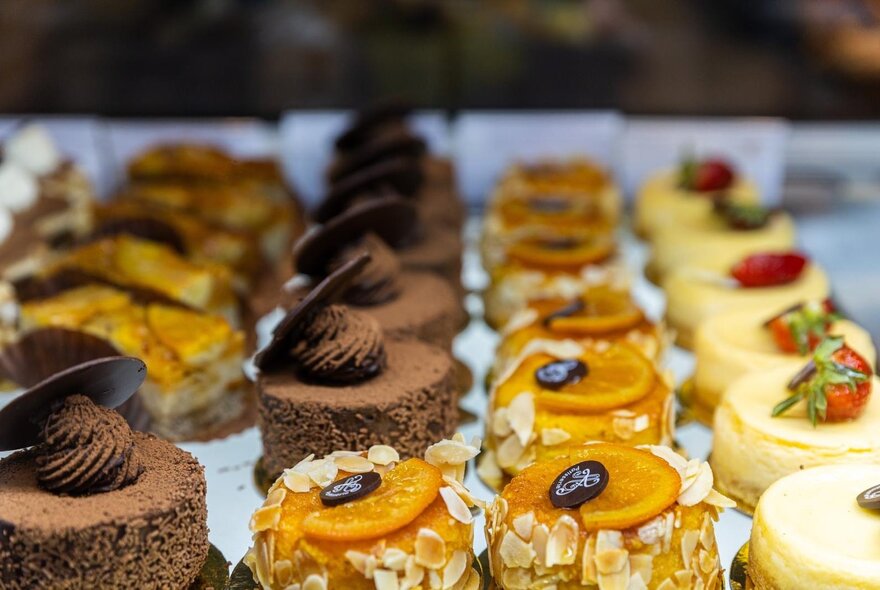 Rows of sweet pastries on display at a cafe.