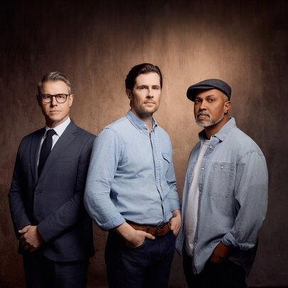 Three male actors - Rodger Corser, David Berry and Bert LaBonté - the lead cast for the stage adaptation of The Shawshank Redemption, posed against a light tan backdrop.