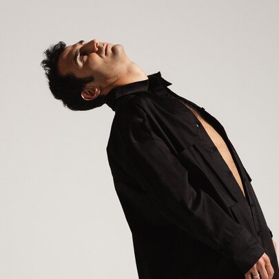 Armenian pianist / composer Tigran Hamasyan leaning backwards with head facing upwards. 