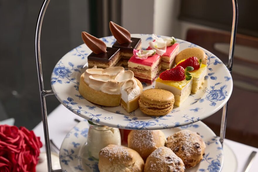 A display of savoury and sweet treats on a three tiered serving plate as part of a High Tea  menu.