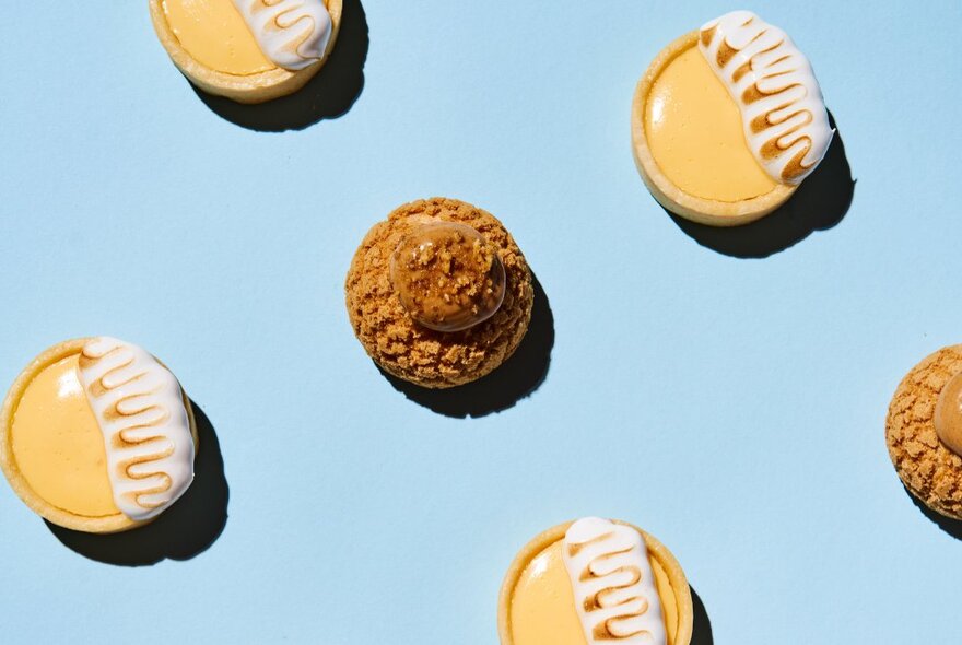 Iced biscuits and macaroon on a blue background.