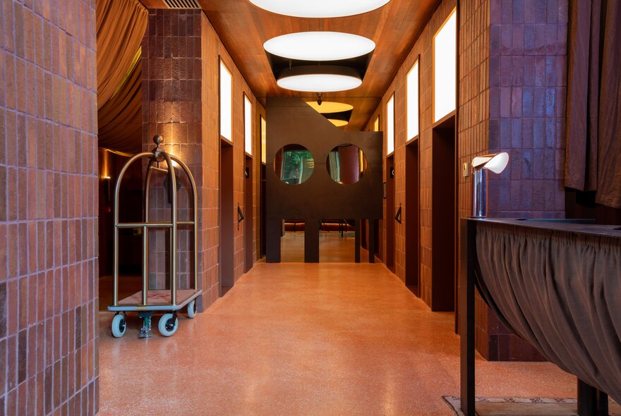 A hotel corridor with orange and purple tones. 