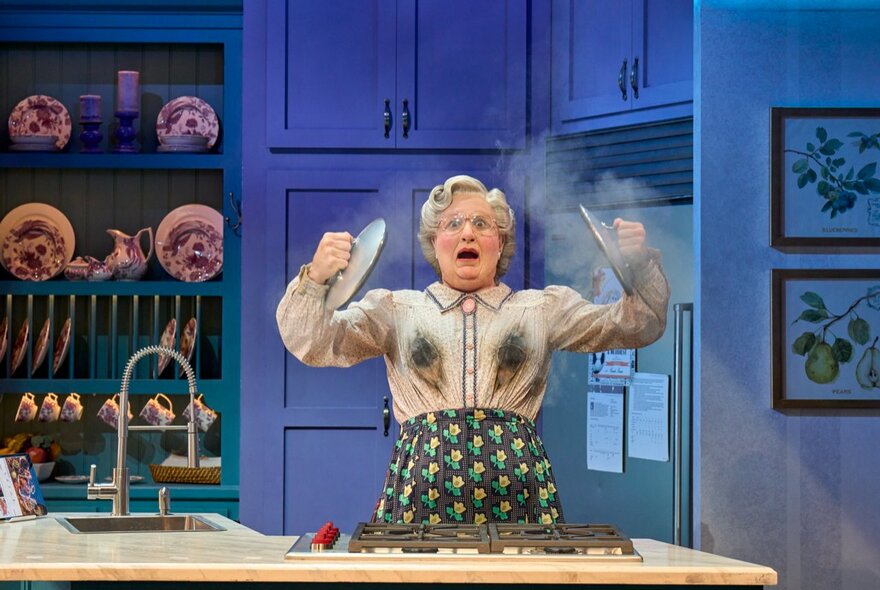 A scene from Mrs Doubtfire The Musical showing the protagonist looking aghast and a puff of steam. 