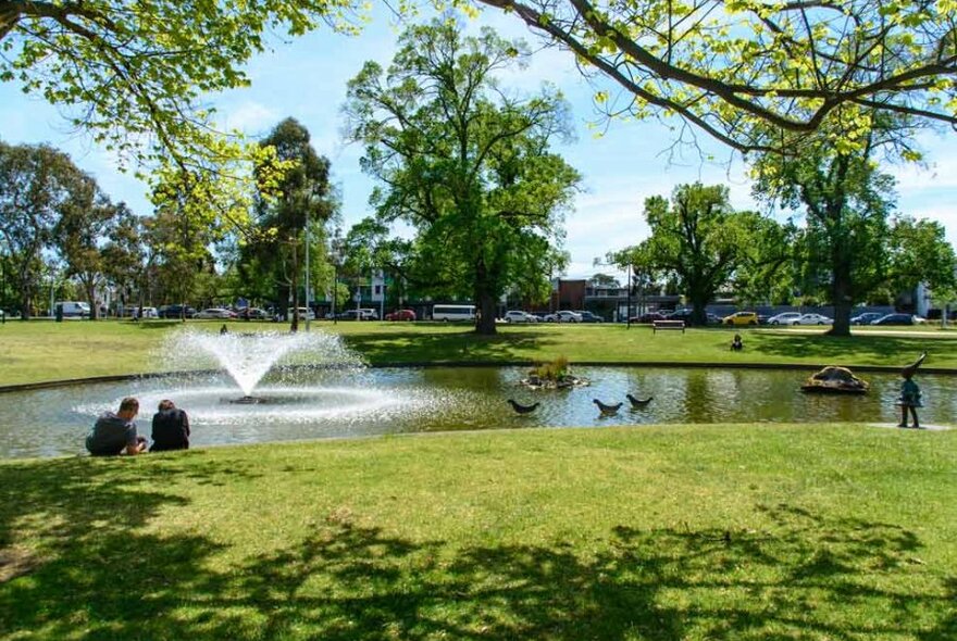 A lake in a public park on a clear afternoon