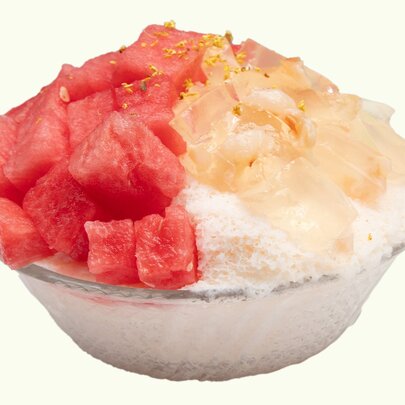 A watermelon shaved ice dessert, topped with lychee jelly and fresh watermelon.