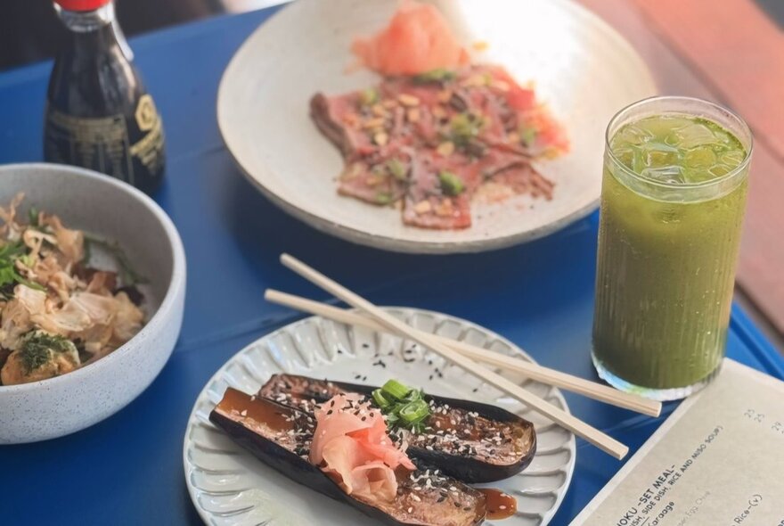 Plates of Japanese food and a drink at Kuru restaurant.