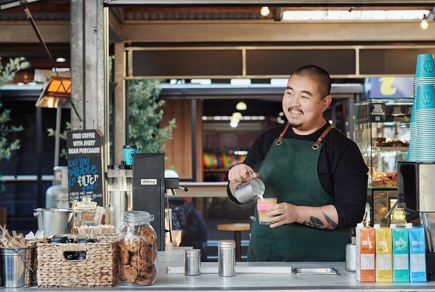 Barista pouring a coffee.