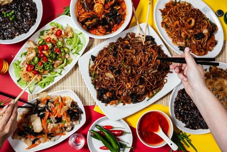 Bowls of noodles, dumplings and asian food on a table