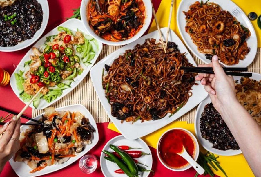 Bowls of noodles, dumplings and asian food on a table