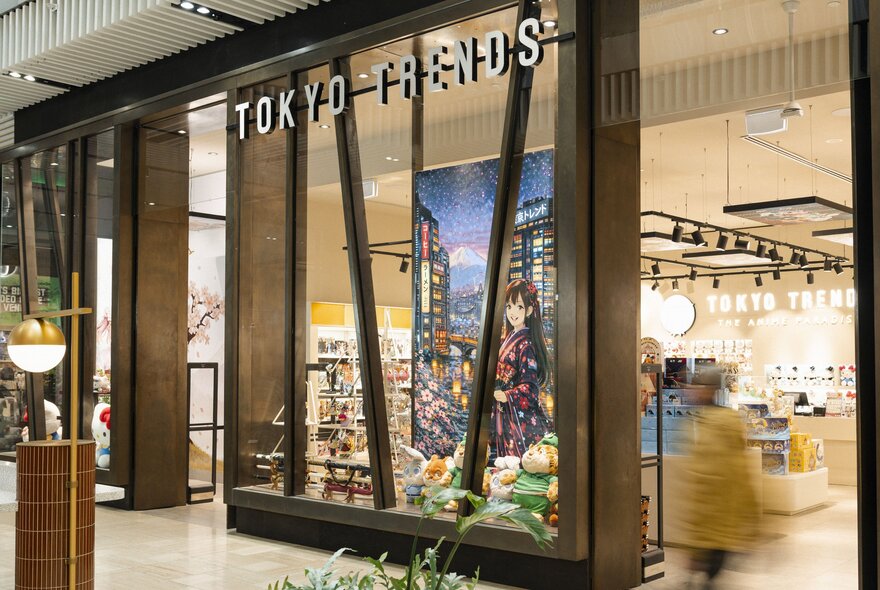 The external facade of a shop called Tokyo Trends, with a large anime poster inside the window.