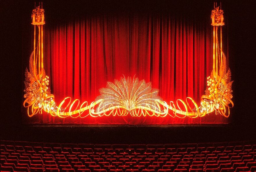 Red theatre stage curtain with gold design at the State Theatre Melbourne.