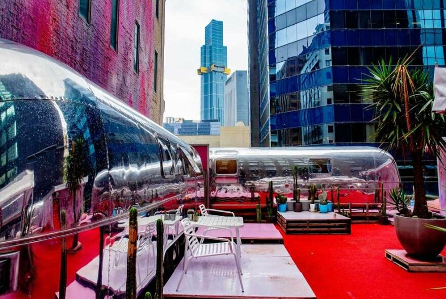 A silver caravan hotel on a rooftop