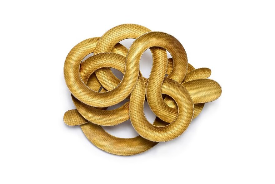 A snake-like coil of gold coloured metal. 