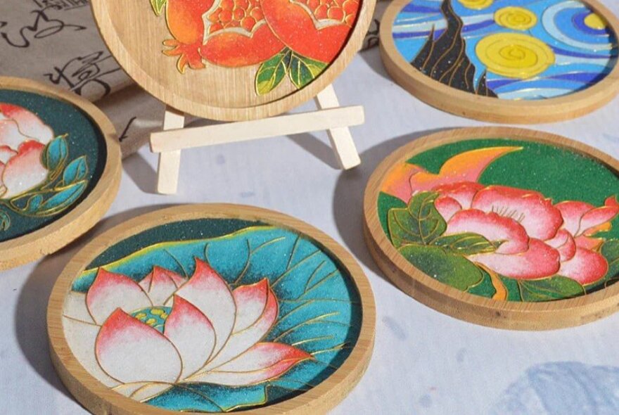 A set of enamel coasters, each with a different flower.