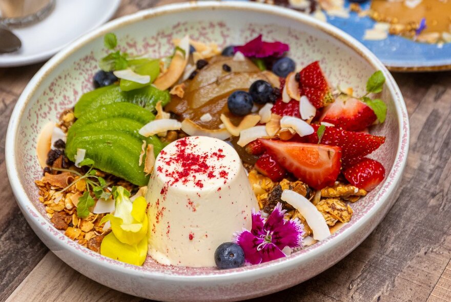 A panacotta with fresh fruit and berries