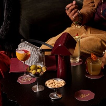 A bar table with cocktails and snacks.