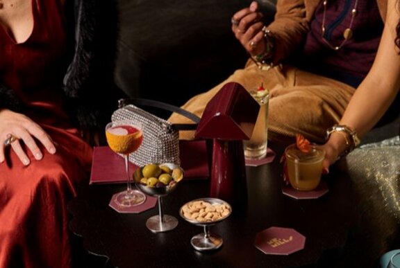 A bar table with cocktails and snacks.