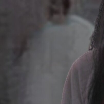 Ghostly shadows and a person with dark hair viewed from behind.