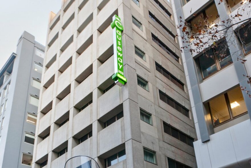 Hotel exterior with signage and multistorey windows.