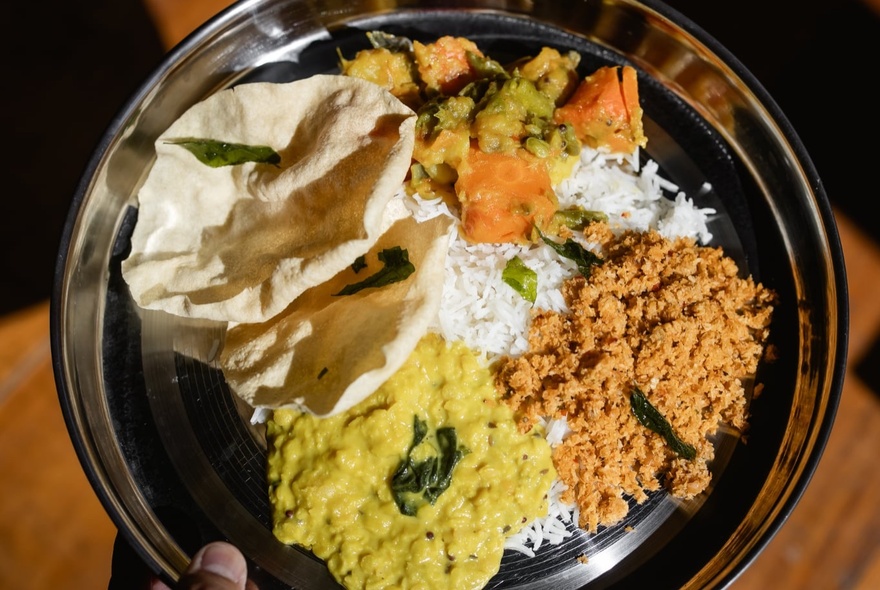 A delicious meal of Sri Lankan food from Lankan Tucker, including rice, dahl and papadams.
