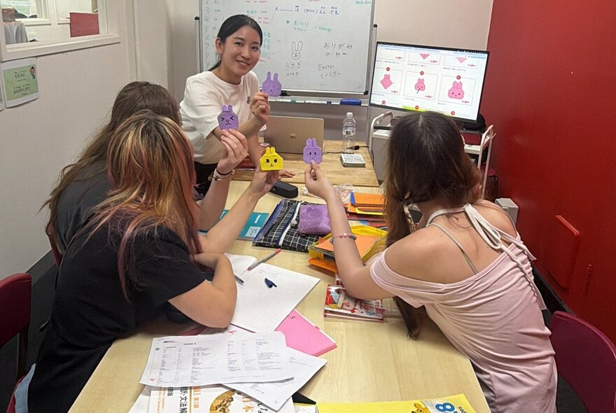 Older kids in a small workshop listening a teacher.