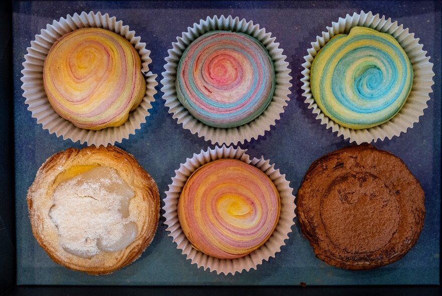 An aerial view of six desserts including Teochew-style "thousand layer" mooncakes and Portuguese tarts.