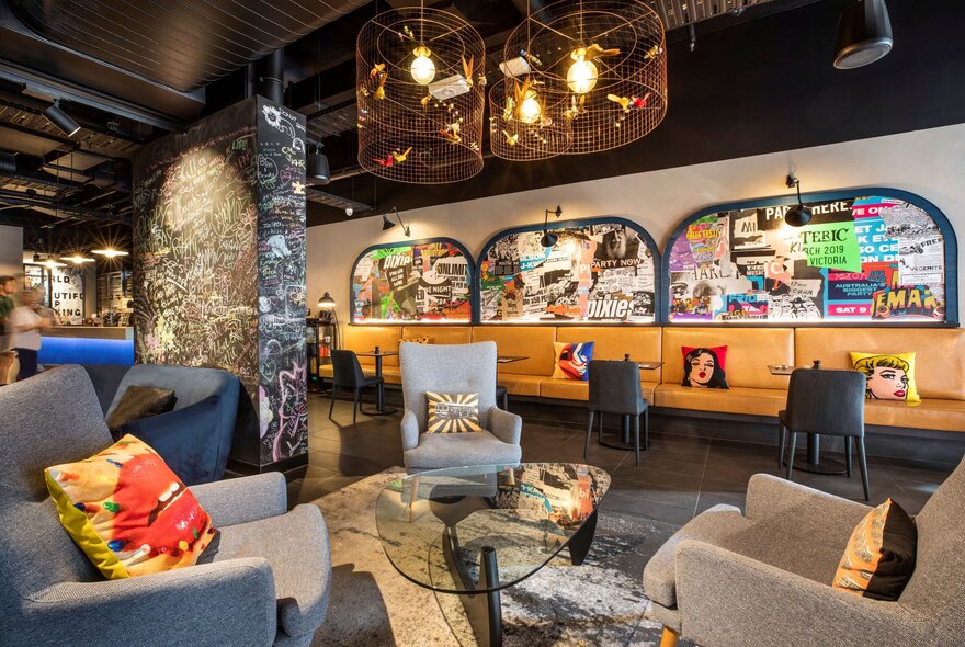 The lobby and lounge area of the Ibis Styles Melbourne Southbank with club lounge and hanging lights.