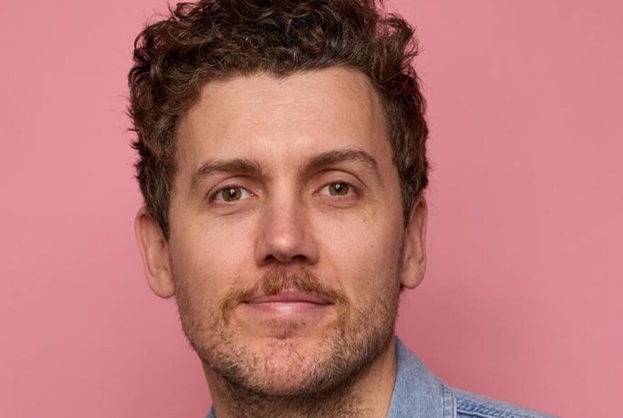Comedian with light goatee and dark hair.