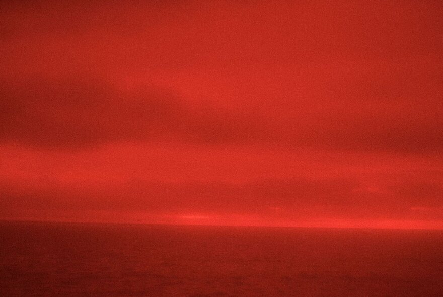 Image of horizon and sky, with a red filter overlaid.