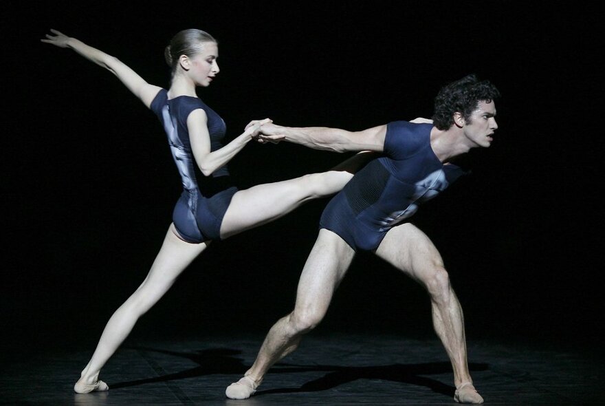 Film still of two people on a stage dancing, both wearing leotards.