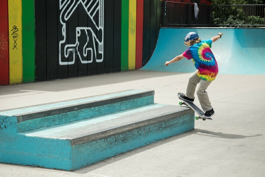 Person on a skateboard grinding at Riverslide Skate Park.