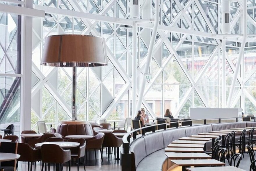 Emporium Melbourne food court with lots of empty tables and three people dining