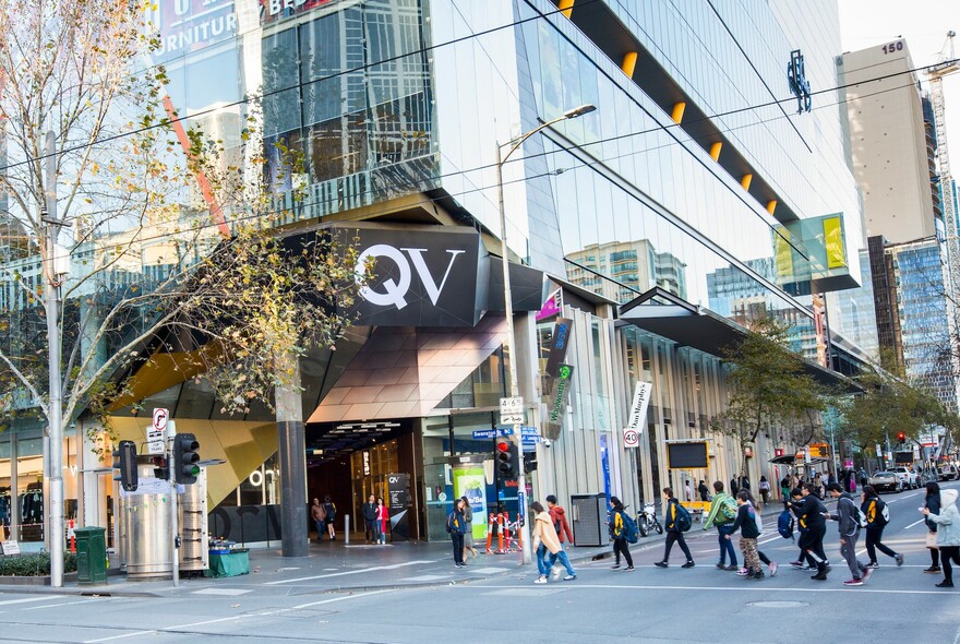 People crossing the street outside QV Melbourne shopping precinct.