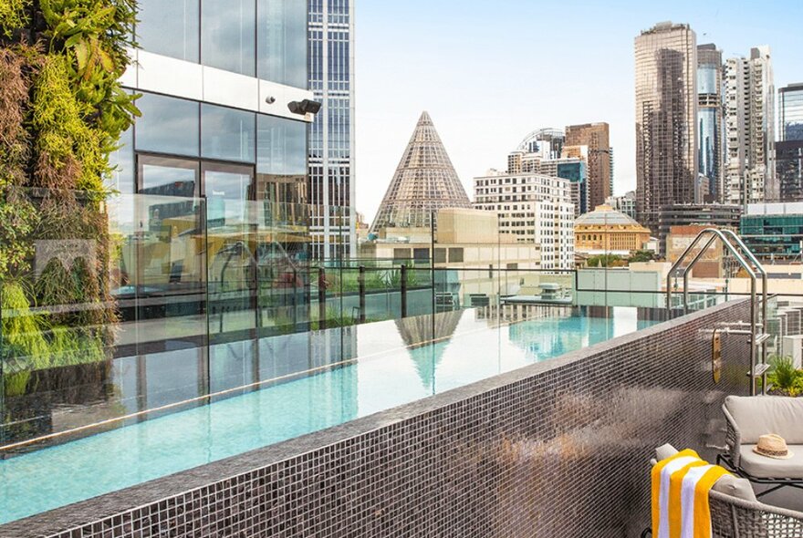 An above-ground tiled pool on a city rooftop.