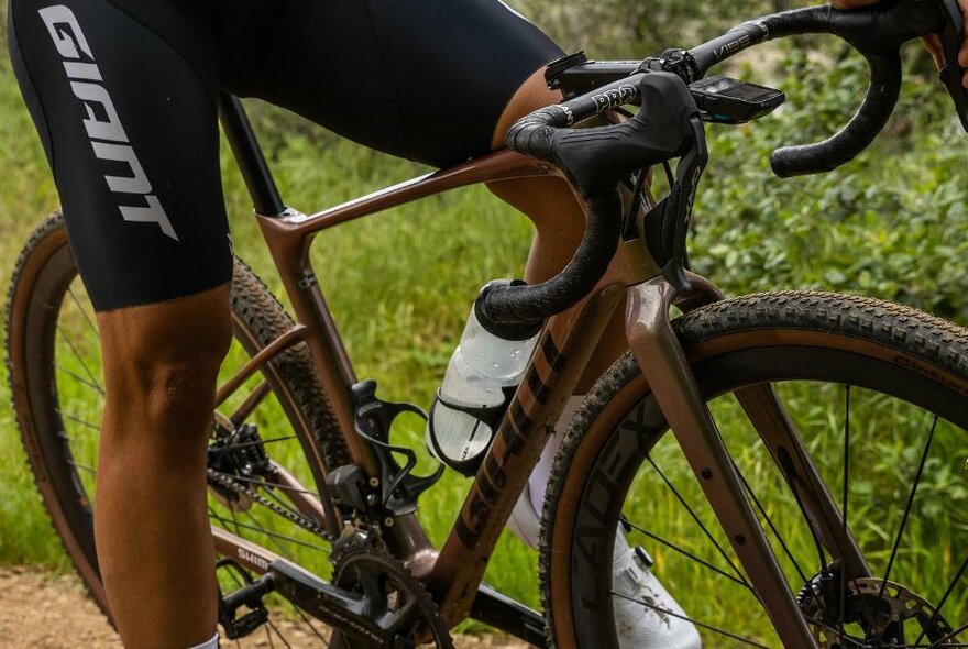 A close-up of a person on a bike wearing bike shorts. 