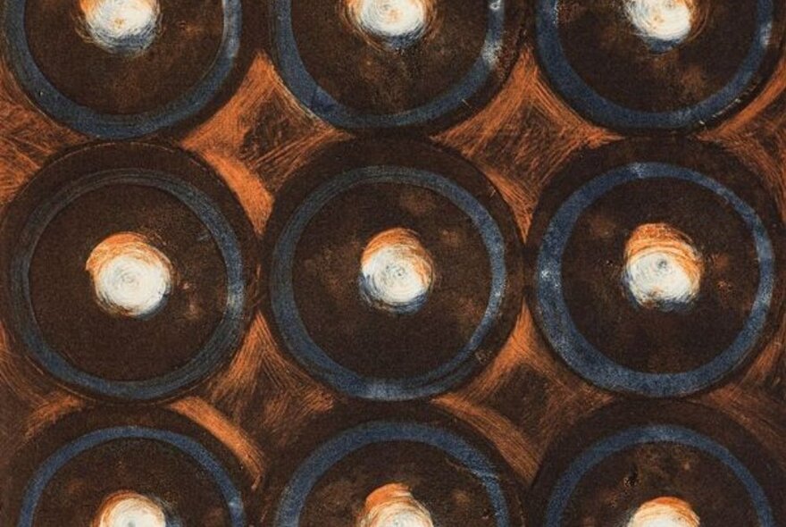 An abstract artwork comprising circles in shades of dark brown and grey.