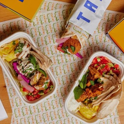 Lebanese takeaway lunch boxes with pita bread, falafel, chicken shawarma and hummus.