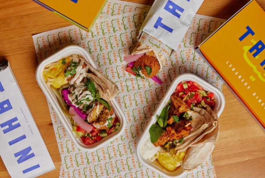 Lebanese takeaway lunch boxes with pita bread, falafel, chicken shawarma and hummus.