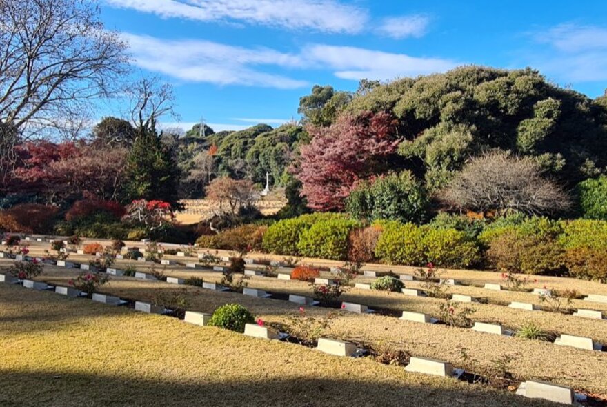 The Yokohama Commonwealth War Cemetery in Japan, showing burial markers in a landscaped garden setting.