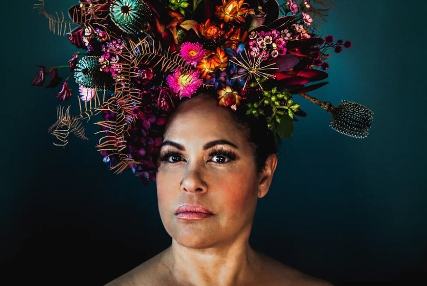 Christine Anu wearing large floral headdress.