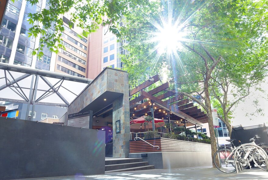 Restaurant venue exterior with steps and lighting.