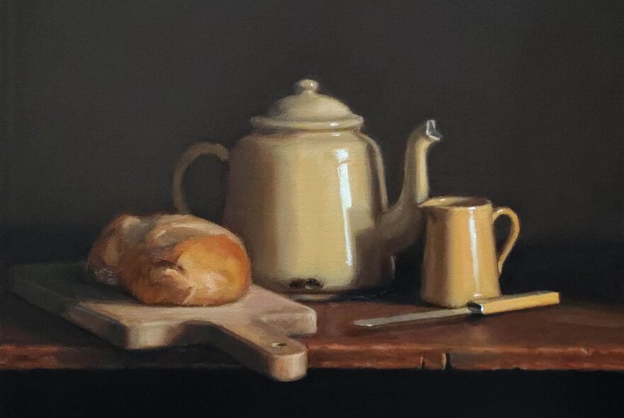 Still life painting of an enamel teapot with a mug, knife and loaf of bread on a board.